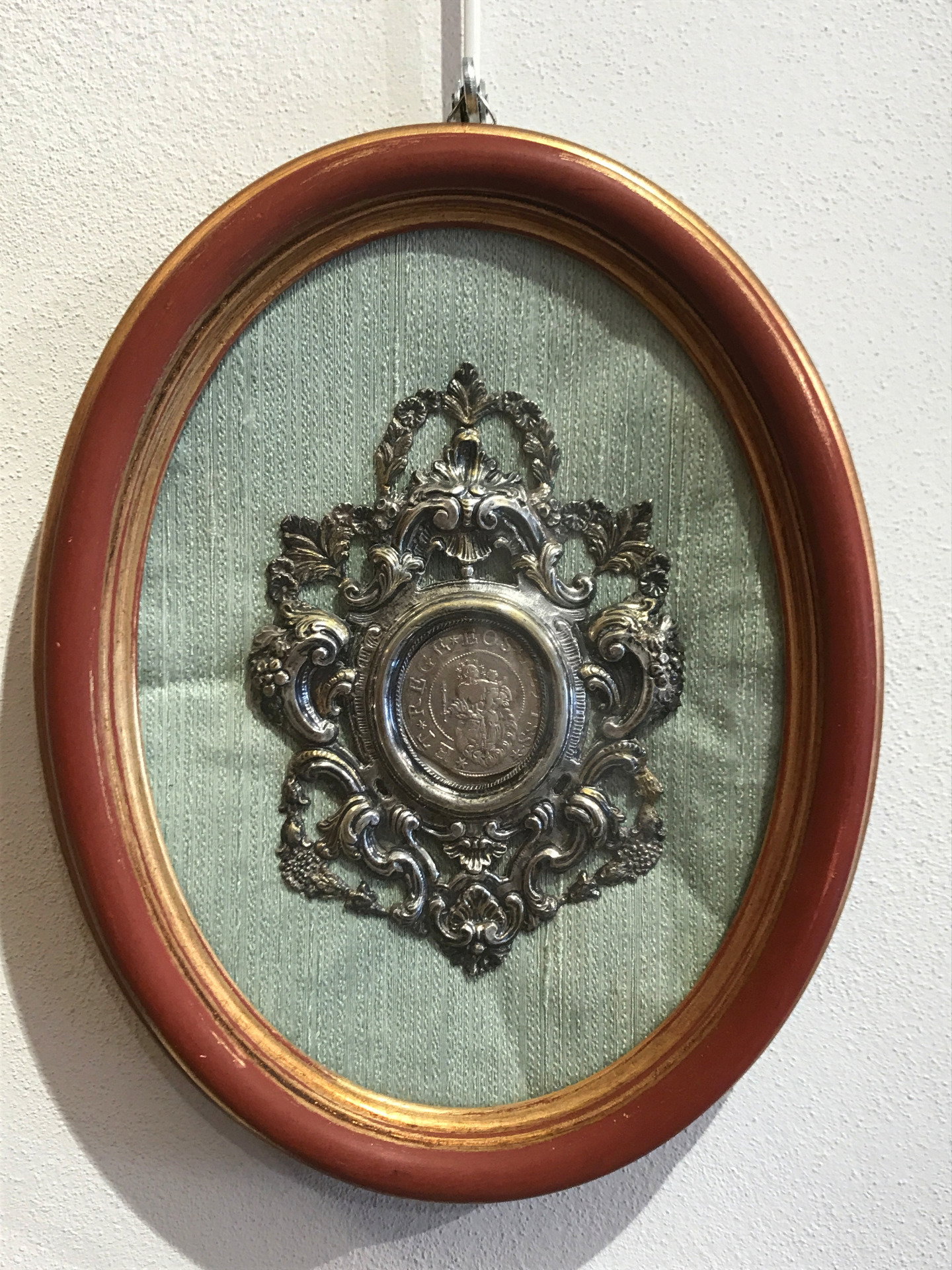 18th-century chased and embossed silver frame containing a Genoese scudo from 1683